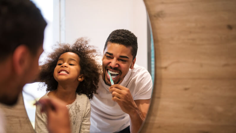dad and kid brushing teeth