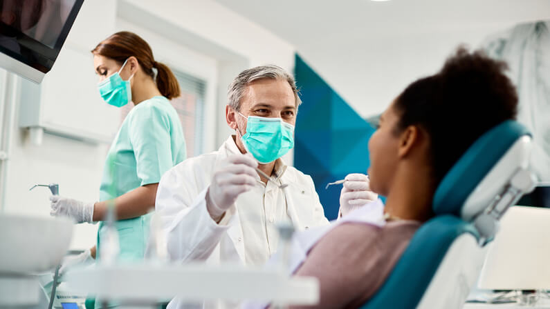 Dentist doing dental service to a patient with cold sore