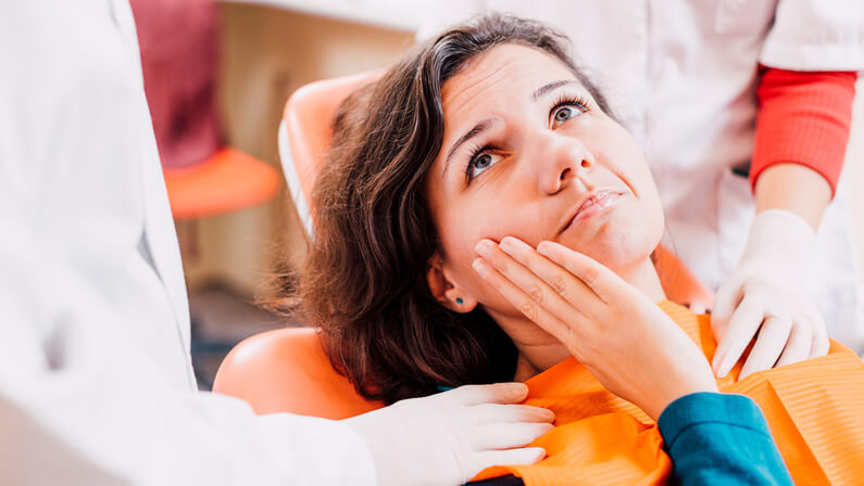 Patient in painful state with the dentists