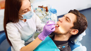 dentist doing dental procedure with the male patient