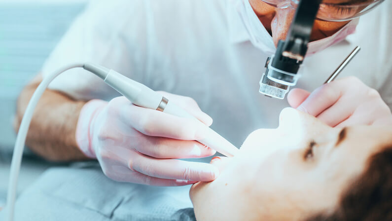 dentist in a dental procedure with the patient