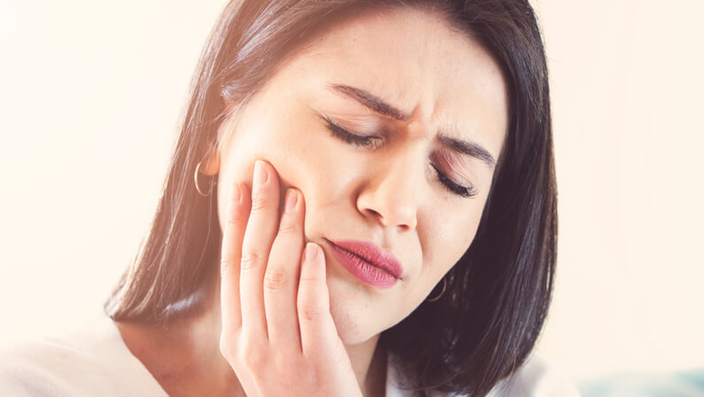 adult woman in pain of toothache