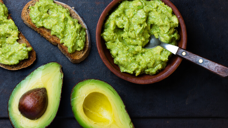 avocadoes in a bowl with spoon