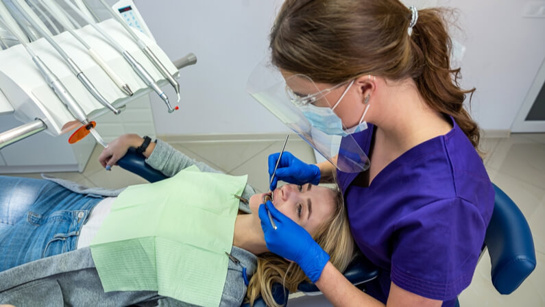 dentist performs Dental Bonding on a female patient