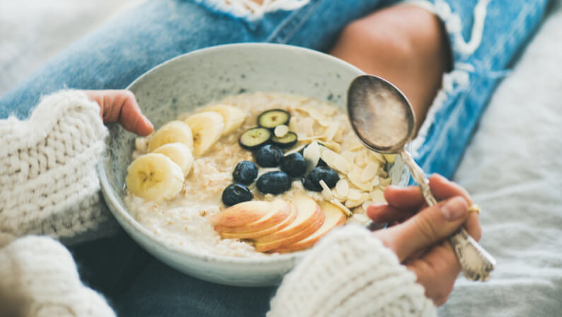 lady eating a bowl of porridge