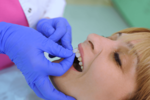 woman at dentist office getting veneers checked