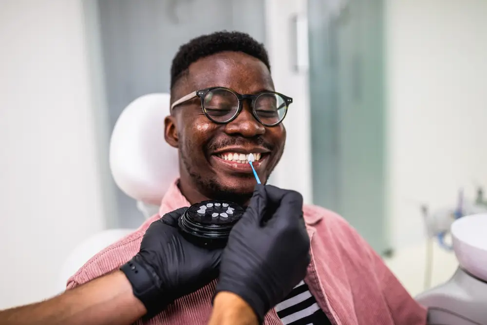 African American man having dental treatment with lumineers at dentist's office.
