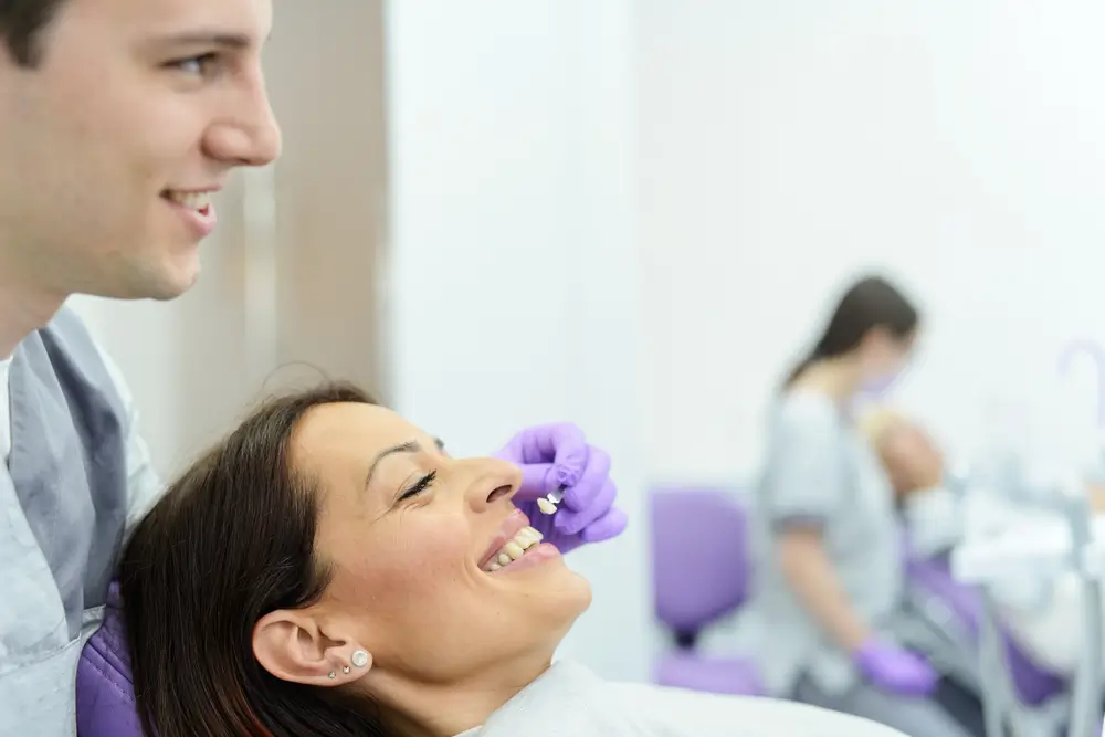 patient choosing the color for her new veneers
