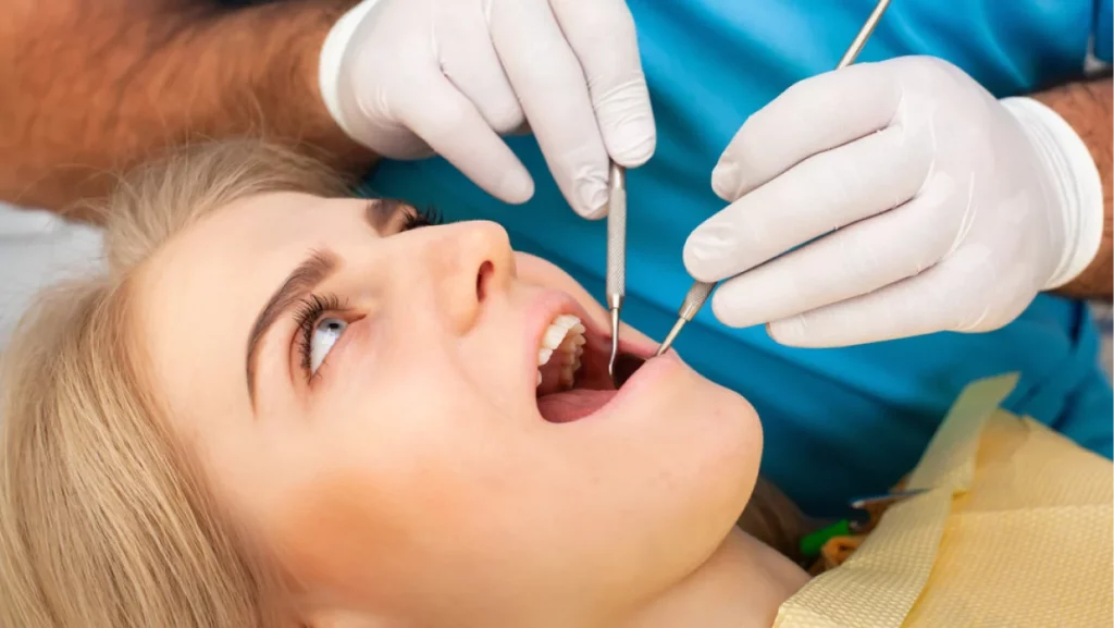 A dentist holding dental tools on patients month 